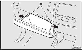 3. While pressing the side of the lower glove box, unhook the left and right