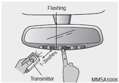 2. Press and hold the button on the HomeLink system you wish to train and the