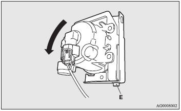 5. In order to secure space to work, remove the bolt (E) and tilt the front fog