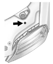 7. Locate the vertical headlamp aiming screws, which are under the hood near